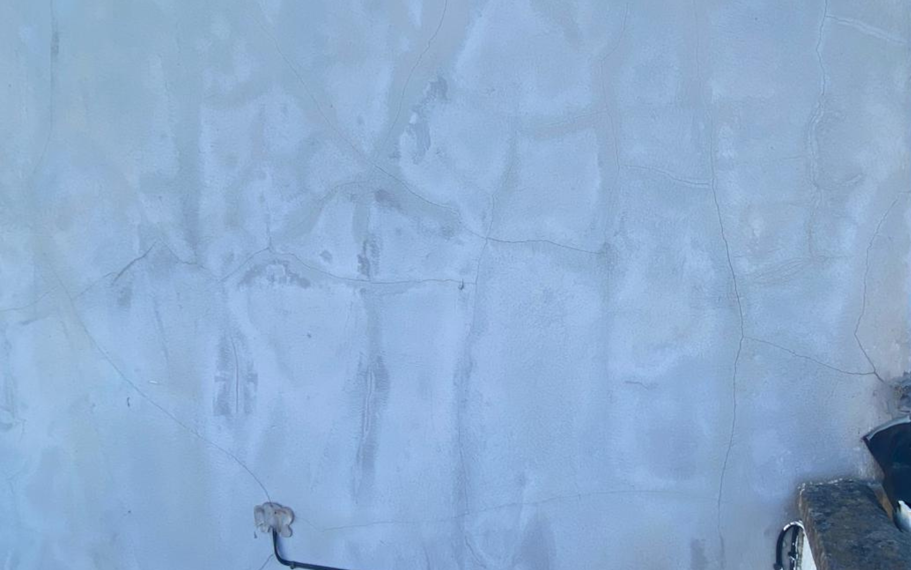 Spiderweb cracks on white wall